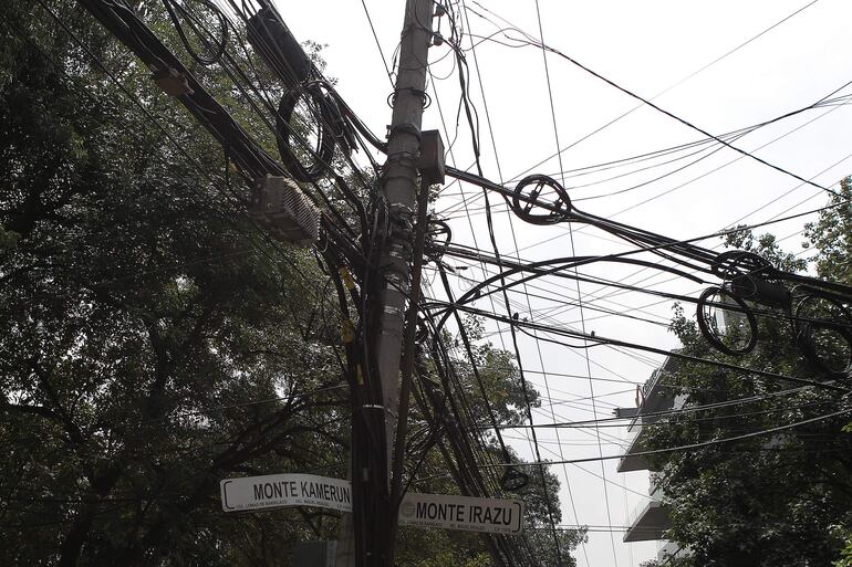 Fotografía de archivo del 10 de agosto de 2018 que muestra un poste con cables en una calle de la Ciudad de México (México).