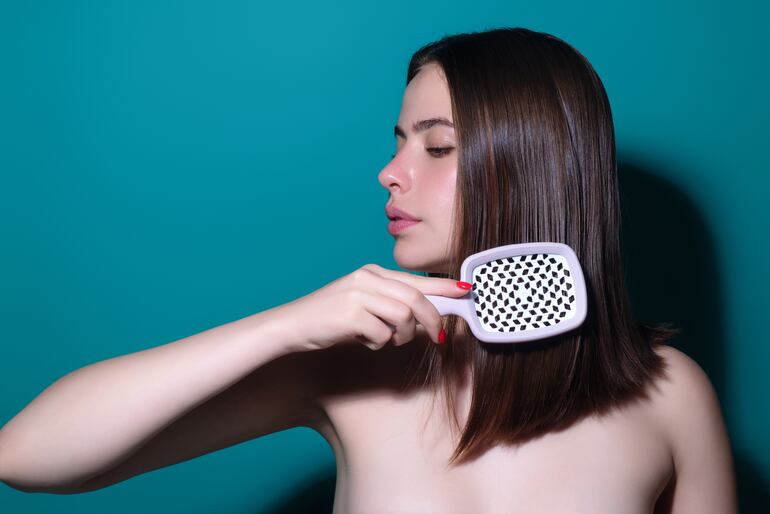 Mujer se cepilla el cabello.