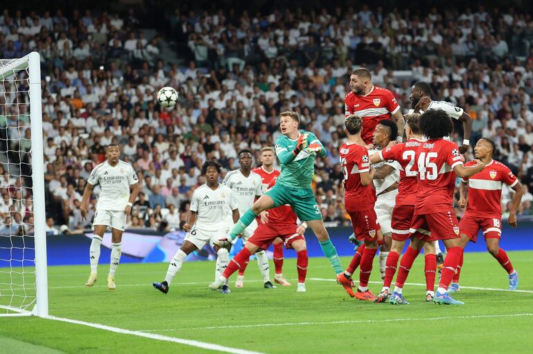 Real Madrid's German defender #22 Antonio Ruediger (Top-R) scores his team's second goal during the UEFA Champions League 1st round day 1 football match between Real Madrid CF and Stuttgart VFB at the Santiago Bernabeu stadium in Madrid on September 17, 2024. (Photo by Thomas COEX / AFP)