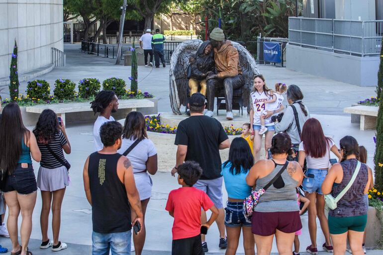 Los fanáticos toman fotografías de la nueva estatua permanente de Kobe Bryant y su hija Gianna Bryant afuera del Crytpo.com Arena en Los Ángeles, California. (Apu Gomes/Getty Images/AFP)
