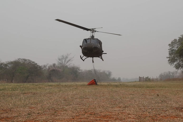 Un helicóptero de la Fuerza Aérea de Paraguay con un contenedor "Bambi".