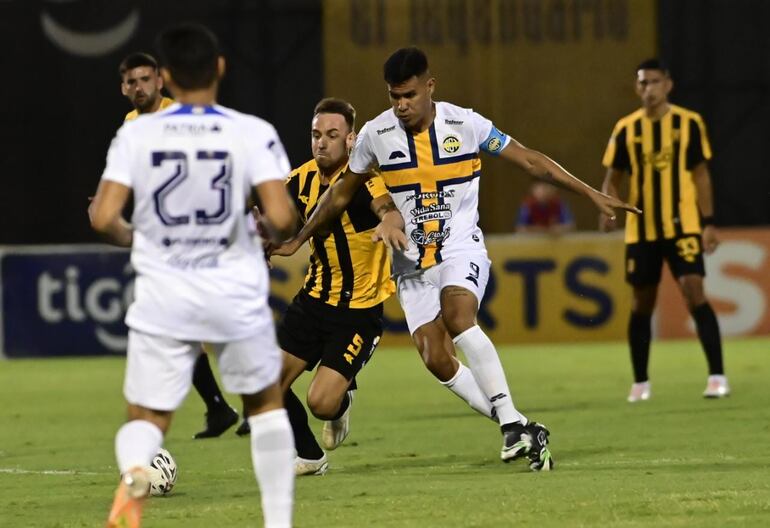 Disputa de balón entre Gastón Gil Romero (Guaraní) y Óscar Giménez (Trinidense).