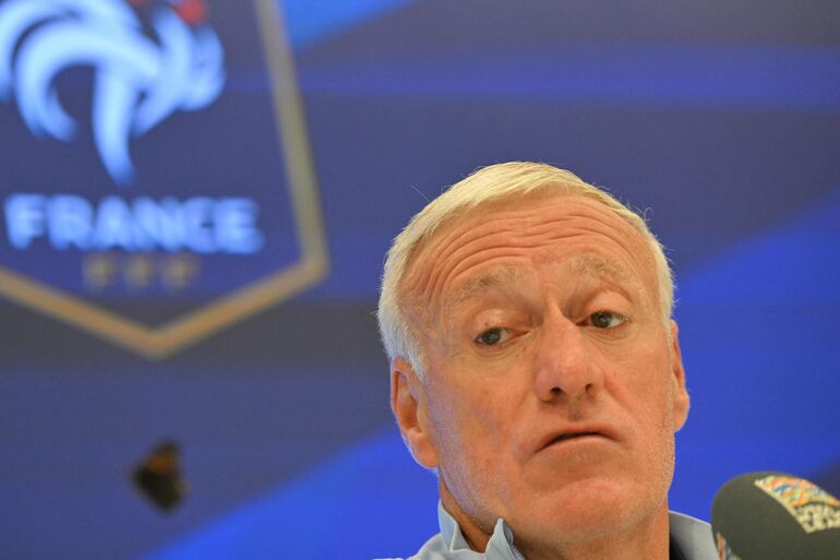 France's coach Didier Deschamps looks at a butterfly flying next to him during a press conference on the eve of the UEFA Nations League group A2 football match against Belgium, at the Roi Baudoin Stadium in Brussels on October 13, 2024. (Photo by NICOLAS TUCAT / AFP)