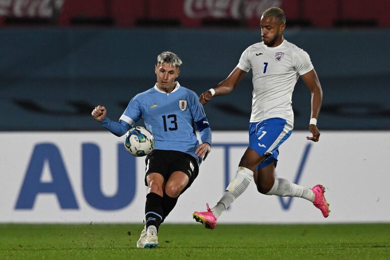 El defensor uruguayo Guillermo Varela rechaza el balón ante el acoso del delantero cubano Willian Pozo, durante el partido amistoso que ganaron los charrúas por 2-0.