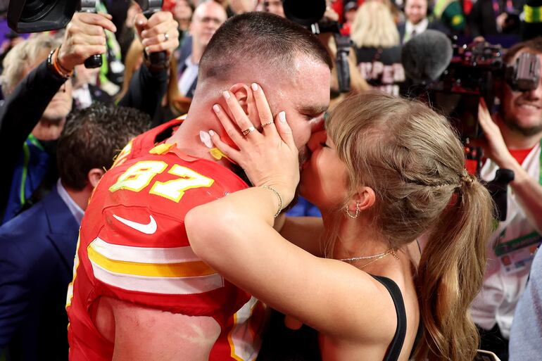 Travis Kelce, de los Kansas City Chiefs, y la cantante Taylor Swift se besan apasionadamente al culminar el Super Bowl LVIII en el Allegiant Stadium.