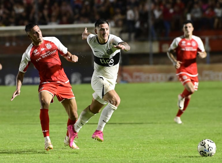 Guillermo Paiva, delantero de Olimpia, pelea por el balón en un partido frente a General Caballero en el estadio Ka'arendy, en Juan León Mallorquín.