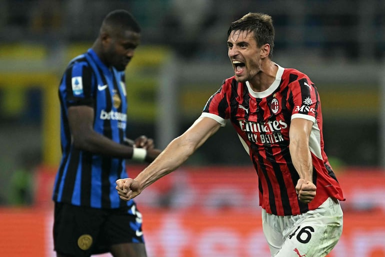 AC Milan's Italian defender #46 Matteo Gabbia celebrates after winning 1-2 the Italian Serie A football match between Inter and AC Milan at San Siro stadium in Milan, on September 22, 2024. (Photo by Gabriel BOUYS / AFP)