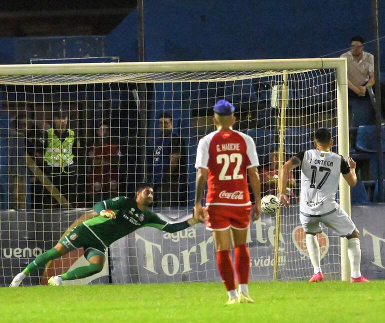 Jorge Ortega remata desde los doce pasos al mismo lugar donde se arroja Rubén Escobar, quien toca el balón, pero no evita el primer gol.