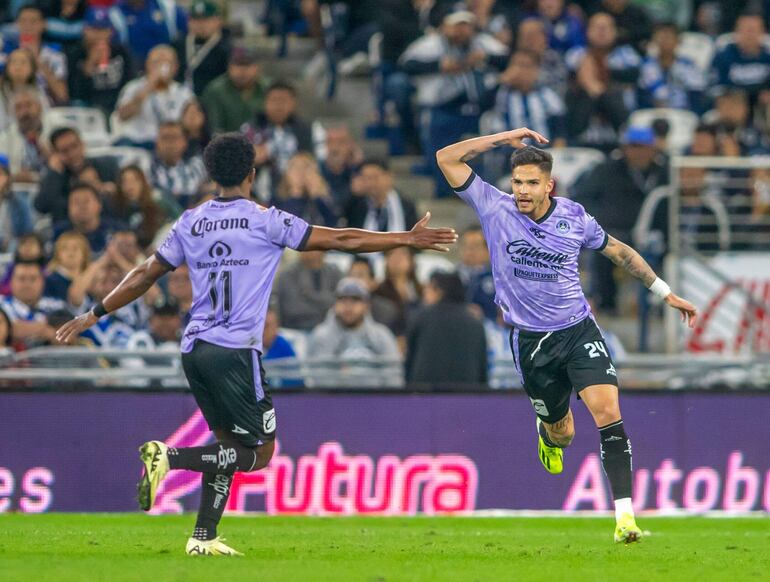 Mazatlan's Luis Amarilla (R) celebrates after scoring against Monterrey during the Mexican Clausura 2024 tournament football match at the BBVA Bancomer stadium in Monterrey, Mexico, on March 10, 2024. (Photo by Julio Cesar AGUILAR / AFP)