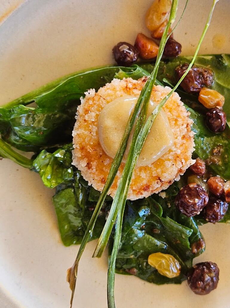 Provoleta de cabra, pasas de uva, ajo tierno, almendras y espinacas. Restaurante Piedra Infinita, de la bodega Zuccardi.